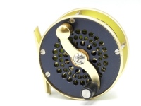 A good Bo Mohlin Mini Trout fly reel and block leather case, gold/dark blue anodised finish, counter-balanced serpentine crank handle set with an anti-foul rim, perforated face and drum plate, bridge foot, triple cage pillars, fixed check mechanism, only