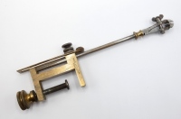 A rare Holtzapffel fly tying vice, brass collared, tapered adjustable iron shaft with butterfly screw locking fly jaws, rectangular brass table clamp fitting, stamped makers name and with milled circular brass locking screw, circa 1900 (see illustration)