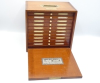 A fine and rare Hardy Unique Salmon fly reservoir, the rectangular polished mahogany case with fall front door, interior fitted ten sliding drawer each with ivorine bun handle, two ivorine index tablets and bars of nickel silver spring fly clips holding a