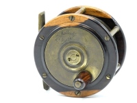 A Malloch Perth style lignum vitae and brass salmon fly reel, tapered rosewood handle on brass winding plate, bridge foot (neatly filed), quadruple cage pillars, fixed check mechanism, faceplate with raised two screw spindle boss and early engraved maker