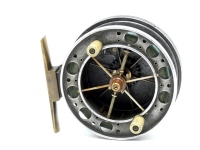 A scarce Allcock Aerial 7950-T6 3 ½" narrow drummed centre pin reel, caged and six spoked drum with rarely seen double ventilated front flange, twin xylonite handles and twin release/regulator forks, brass stancheon foot, rear sliding optional check butt