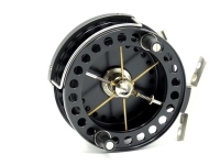 A Young's Purist II model 2048 limited edition 3 ¾" centre pin reel, black anodised finish, shallow cored drum with twin composition handles, six spokes, twin release/regulator forks, pierced alloy foot, wire B.P. line guide, rim mounted optional check l