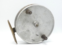 A Hardy Natal Surf 7 ½" sea centre pin reel, solid narrow drum with tapered ebonite handles and milled brass spindle tension adjusting nut, brass stancheon foot, faceplate stamped make and model details, wear from normal use, 1930's