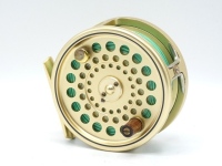 A Hardy Sovereign 8/9 salmon fly reel and spare spool, gold anodised finish, counter-balanced rosewood handle, two screw spring latch, rear sliding optional check button and milled spindle mounted tension adjuster, ltd. ed. no. 743, in hide zip cases