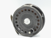 A Hardy St John 3 7/8" light salmon fly reel, ebonite handle, ribbed brass foot, white agate line guide (no cracks) three screw spring drum latch, milled rim tension screw and Mk.II check mechanism, only very light wear to dark lead finish, circa 1930