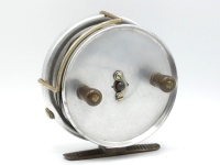 A scarce Hardy Longstone General Harrison Pattern 5" duralumin sea centre pin reel, solid drum (no perforations) with twin reverse tapered ebonite handles and nickel silver telephone drum latch, ribbed brass foot, Bickerdyke line guide, rim mounted option
