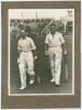 M.C.C. Australian Touring Team v C.I. Thornton&rsquo;s XI, Scarborough 1928. Original mono photograph of Ernest Tyldesley (Lancashire) and Maurice Tate (Sussex) walking out to bat for M.C.C. at Scarborough with crowds in the stands in the background, for the ma