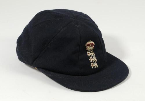 Kenneth Shuttleworth. Lancashire, Leicestershire & England 1964-1980. England Test cap worn by Shuttleworth during his England playing career. The navy blue cap with central emblem of three lions and a crown to front. Some minor staining and wear to the c