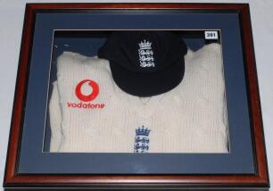 Peter Such. Essex, Leicestershire, Nottinghamshire & England 1982-2001. England sweater and cap formerly the property of Peter Such presented in a display case. The cap and sweater with the England three lions and crown emblems, the sweater with &lsquo;Vodafone