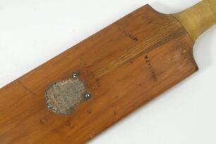 An early presentation cricket bat. An mid to late 19th Century cricket bat from 1874 made by William Page of Dulwich. The bat is slim and slightly humped. The bat is topped by a button cap and is not sprung. There is a silver metal shield to the back of t