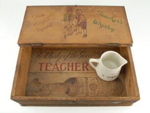 ‘The Right Spirit’. Original Teachers Whisky wooden box with image of boys playing cricket and Teacher’s Whisky advertising printed to inside boards. 16.75”x10.5”. 4” deep. Sold with a transfer printed, 4” jug, with boy cricketers to one side and ‘Teacher