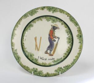 ‘I was’nt Ready’. A Royal Doulton ‘Black Boy’ bone china dinner plate, entitled ‘I was’nt ready’ printed with a boy in red shirt, yellow waistcoat and a floppy hat looking glum with his wicket broken behind him. Green floral decoration to inner and outer 