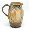 Doulton Lambeth stoneware jug, of ovoid form, moulded with relief vignettes of cricketers, a batsman, bowler and wicket keeper, Abel, Woods and McGregor in white on a brown background. With stylised daisy and floral leaf Art Nouveau decoration to top and - 4