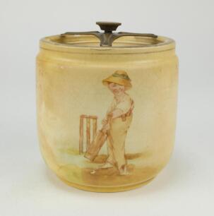 Cricket tobacco jar. A Fielding & Co brown tobacco jar and lid printed to sides with a vignette of a batsman in blue striped cap and to the other side a boy in a floppy hat similar to the Kinsella boy, interspersed with a tree design. The jar being hermet