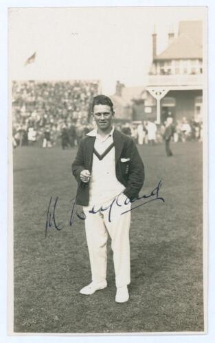 Maurice Leyland. Yorkshire, Patiala & England 1920-1946. Mono real photograph postcard of Leyland standing full length on the outfield at Scarborough, wearing cricket attire and England blazer, cigarette in hand. Nicely signed in black ink to the photogra