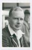 George Rammell Taylor. Hampshire 1935-1939. Mono real photograph plain back postcard of Taylor, head and shoulders wearing cricket attire and blazer. Official stamp to verso for A. Wilkes & Son, West Bromwich, and dated 1939. Good/ very good condition.
