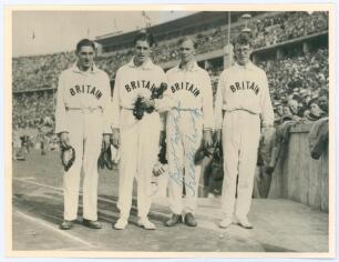 Olympic Games Berlin 1936. Original sepia photograph of the Great Britain 4x400m relay team who won gold at the 1936 Olympics, beating the American team, including Jesse Owens, who took silver. The four athletes are standing full length in one row wearing