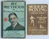 My Methods or Boxing as a Fine Art&rsquo;. Georges Carpentier 1914. Pictorial blue hardback boards. Some breaking to spine block, boards soiled, wear to board extremities, internally good. Sold with &lsquo;Modern Boxing: A Practical Guide to Present-Day Methods&rsquo;. Bom