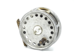 A scarce Hardy St George 3 3/8" "spitfire" alloy trout fly reel, ebonite handle, three screw latch, ribbed brass foot, white agate line guide (no cracks), milled rim tension screw and Mk.I check mechanism, interior stamped "J.S." (Jimmy Smith), wear to f