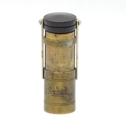 A rare Hardy Zephyr brass pocket oil bottle, the cylindrical shaped container with retractable inner reservoir, turned rosewood cap and cork stopper mounted on two nickel silver hinged arms, lower receiver stamped maker's details and Royal Coat of Arms, c