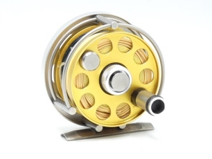 An Ari't Hart Round I trout fly reel, left hand wind model, gold anodised spool with counter-balanced handle and milled spool locking nut, three quarter annular line guide, bridge foot, polished alloy backplate with six ventilation ports and spindle mount