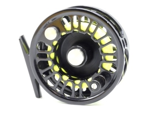 An Abel Super 5N trout fly reel, lack anodised finish, large arbour drum with counter-balanced wooden handle and push button spool release, rear spindle mounted milled tension adjuster, light signs of use, in pouch