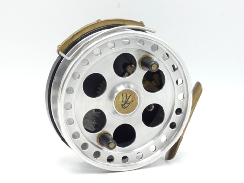 A Dave Swallow Mk.II 4 ½" centre pin reel, shallow cored polished alloy drum with twin tapered handles and six ventilation ports to face, milled batting rim, B.P. line guide, brass stancheon foot, rim mounted optional check lever and bar spring check mech