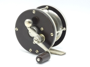 An Edward Vom Hofe Celebrated Bass/Universal 1/0 multiplier reel, ebonite and nickel silver construction with off-set crank winding arm, pierced nickel silver off-set foot, rim tension lever and triple cage pillars, circa 1910