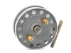 A scarce W. F. Homer 3 ½" "The Homer" centre pin reel, shallow cored drum with twin horn handles, ventilated front plate and milled brass spindle tension nut, brass stancheon foot, rear sliding optional check button and calliper spring check mechanism, b