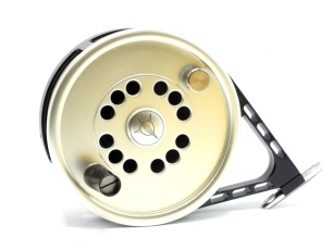 A Steel Fin Abyss 5 ¾" big game fly reel, shallow cored gold anodised drum with counter-balanced composition handle and milled spindle locking nut, triform foot, black anodised cage and rear sliding rim tension adjuster arm, only light signs of use, in or