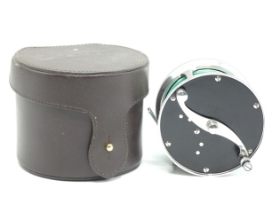 A Loop Classic 811 salmon fly reel and block leather case, right hand wind model with black anodised end plates, counter-balanced serpentine scroll handle, block foot, rear spindle mounted tension adjuster, light wear only (see illustration)