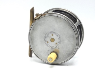 A Hardy Perfect 3 ¾" salmon fly reel, ivorine handle, brass foot, strapped rim tension screw with Turk's head locking nut and 1912 check mechanism, slightly dished drum with four rim cusps and milled nickel silver locking screw, faceplate stamped central 