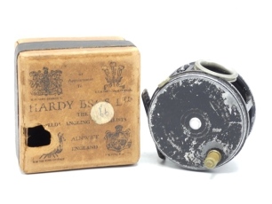 A scarce Hardy Perfect 3 ¼" "wartime" finish light salmon fly reel, xylonite handle, ribbed brass foot, revolving nickel silver line guide, milled rim tension screw and Mk.II check mechanism, interior stamped "J.S." (Jimmy Smith), wear to black painted fi