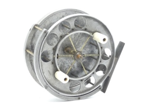 An Allcock Aerial 7950-T5 4 ½" centre pin reel, caged and six spoked drum with twin xylonite handles (replacement), perforated front flange (eight holes) and twin release/regulator forks, B.P. line guide, brass stancheon foot, rear sliding check button a