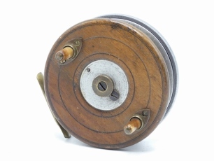 A very rare Allcock Brigald 4" centre pin trotting reel, alloy backed walnut drum with twin horn handles on brass elliptical cups, central milled brass patent spindle tension adjusting nut, brass star back foot with sliding optional check button and prev