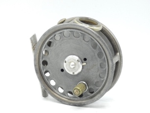 A scarce Hardy St George 3 3/8" silent check trout fly reel, shallow cored drum with xylonite handle and three screw spring latch, alloy foot, white agate line guide (two fine hairline cracks), milled rim tension screw and 1920 silent pressure brake check