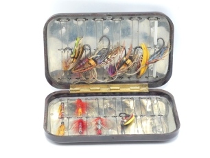 A Hardy Neroda bakelite salmon tube fly box, oxblood finish, interior fitted forty eight spring locking wire tube fly holders, containing six gut eyed fully dressed salmon flies and five tube flies, 1950's