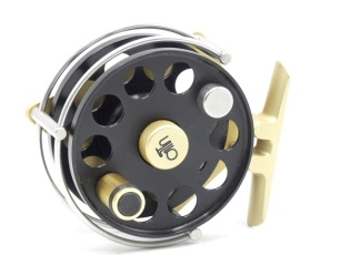 An Ari't Hart Gallatin TR2 trout fly reel, left hand wind model, black anodised drum with counter-balanced handle and milled drum locking nut, three quarter wire line guide, gold anodised triform stancheon foot with sliding optional check button and spind