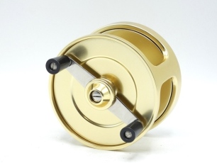 A Fin-Nor No.4 anti-reverse saltwater 3 ¾" fly reel, left hand wind model with gold anodised finish, twin composition handles on crass-bar arm mounted below a milled spindle tension adjusting wheel, only very light use, in original zip case (see illustrat