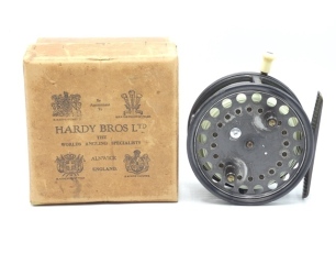 A Hardy Silex Major 4 ½" wide drummed bait casting reel and card box, shallow cored drum with twin ebonite handles, jewelled spindle bearing and spring release latch, ribbed brass foot, rim mounted ivorine casting trigger, milled tension regulator and rea