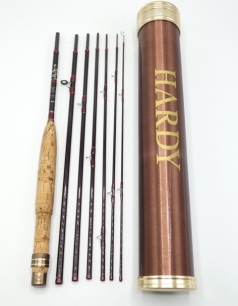 A Hardy "Smuggler Deluxe" 7 piece trout fly rod, 8' 2½", #6, crimson/scarlet tipped wraps, bronze anodised sliding reel fitting, spigot joints, little used condition in bag and original bronze anodised alloy tube