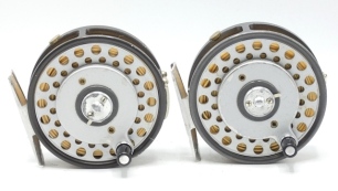 Two Hardy LRH Lightweight multiplier trout fly reels, each with composition handle on raised winding plate, alloy foot, milled rim tension screw and dual compensating check mechanism, one with two screw "U" shaped nickel silver line guide, one with single