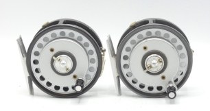 Two Hardy Featherweight multiplier trout fly reels, each with composition handle on raised winding plate, alloy foot, milled rim tension screw and dual compensating check mechanism, one with two screw "U" shaped nickel silver line guide, one with single s