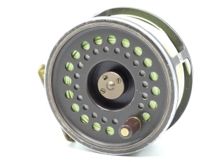 A Hardy Golden Prince 11/12 1st edition salmon fly reel, brown/gold anodised finish, composition handle, ribbed brass foot, spring drum latch, rear spindle mounted tension adjuster, used condition and a Sage "10161-4" 4 piece carbon salmon fly rod, 16' 1