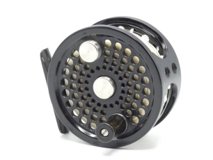 An Abel No.2 saltwater/light salmon fly reel, black anodised finish, counter-balanced handle, block foot, rear spindle mounted milled tension adjuster, light use only, in original pouch