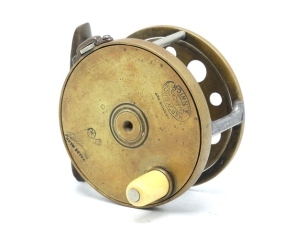 A rare Hardy 1895 Brass Perfect Houghton Dry Fly 2 5/8" wide drummed trout fly reel, ivorine handle, waisted bridge foot, neatly reduced, triple nickel silver drum pillars, one with curved steel pillar protector, strapped rim tension screw and early call