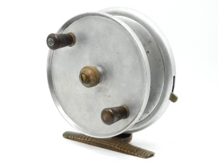 A Hardy South African Surf 6" sea centre pin reel, solid drum with twin reverse tapered ebonite handles and milled spindle mounted tension nut, rim mounted optional check lever, ribbed brass "frog back" stancheon foot, backplate stamped make and model de