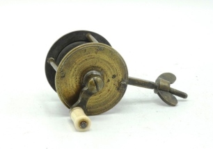 A 19th Century brass spike winch, turned bone handle on curved crank winding arm with domed locking screw, triple cage pillars, block foot with square tapered threaded spike fitting and butterfly wing locking nut, 1 ½" diameter, circa 1850 (see illustrati