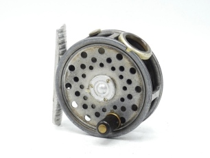 A Hardy St George Junior trout fly reel, ebonite handle, ribbed alloy foot, three screw sprig drum latch, white agate line guide (no cracks), milled rim tension screw and Mk.II check mechanism, backplate stamped make and model details, wear from normal us