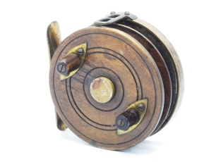 A rare Nottingham double spooled 3 ¼" centre pin reel, walnut brass backed drum with twin tapered treen handles, nickel silver spindle cap and twin line holding sections, double eyed brass line guide, lacquered brass backplate with stancheon foot, sliding